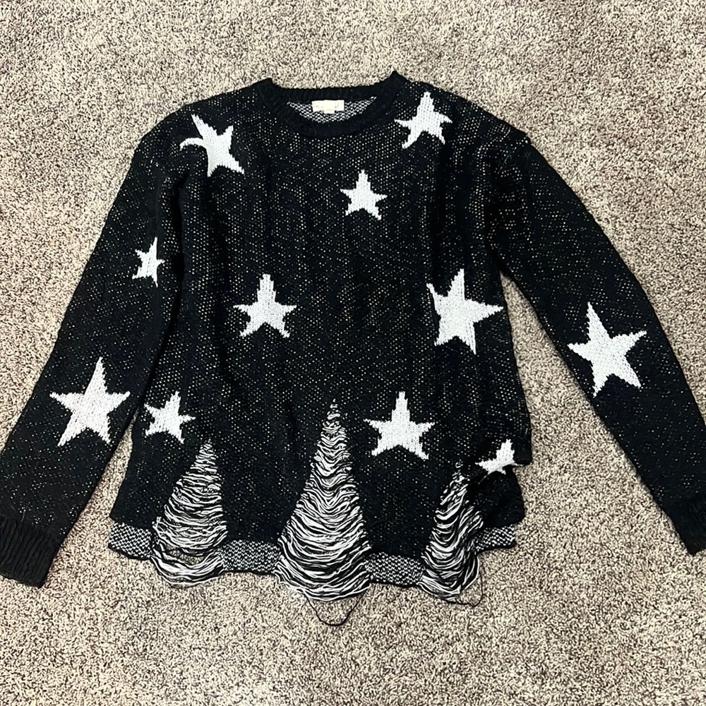 soft black sweater size small with white stars and distressing at the bottom